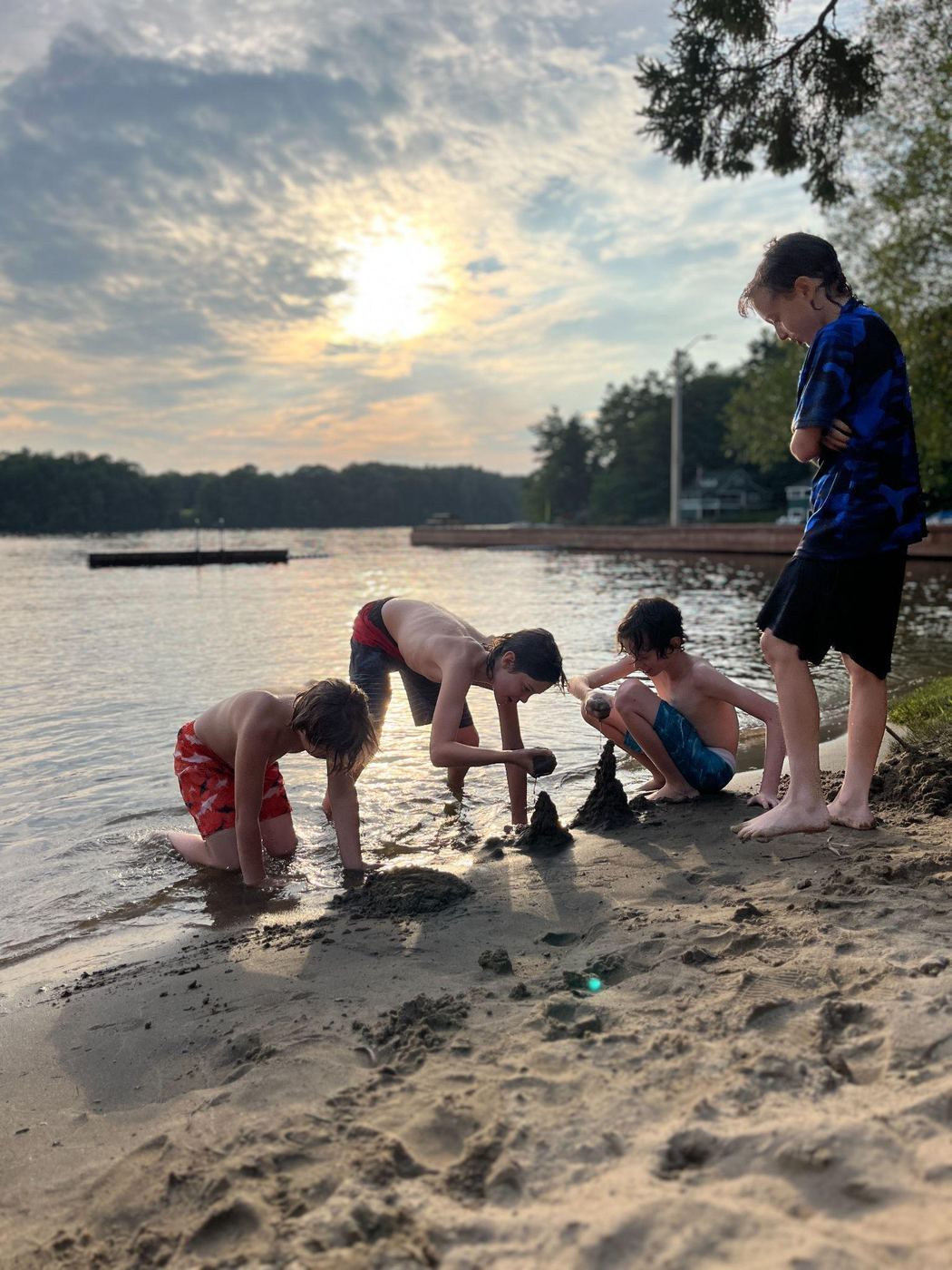 The boys at the Muskoka lake beach at sunset